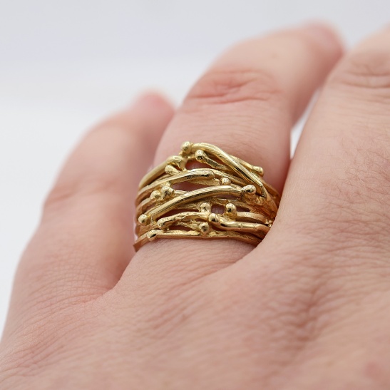 leuve_gouden_ring_met_veel_bandjes_en_bolletjes_drukke_speelse_ring_voor_dames_geelgoud