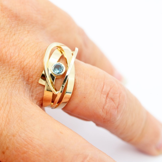 liefde_gouden_ring_met_zeegroene_saffier_aan_de_hand_gedragen